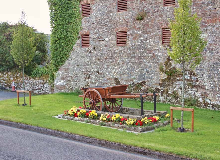Stone wall and cart feature beside Castlelyons Castle.